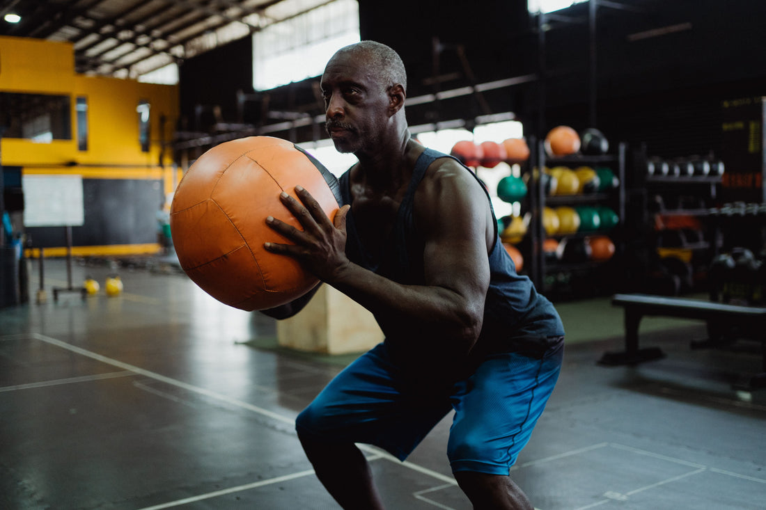 Athlete holding a medicine ball in a squat